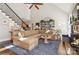 Spacious living room boasts high ceilings, a cozy fireplace, large sectional sofa, and beautiful natural light at 1813 Wedowee Ct, Rock Hill, SC 29732