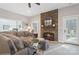 Inviting living room showcasing a stone fireplace, comfortable seating, and an open doorway at 1813 Wedowee Ct, Rock Hill, SC 29732