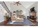 Inviting living room with a fireplace, tall ceilings, ample seating, and natural light filtering through the windows at 1813 Wedowee Ct, Rock Hill, SC 29732