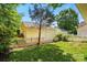 Charming backyard view, featuring a lush lawn and a white picket fence surrounding the perimeter at 19416 Fridley Ln, Cornelius, NC 28031
