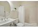 Bathroom featuring a white vanity, toilet, and shower-tub combination at 19416 Fridley Ln, Cornelius, NC 28031