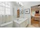 Bright white bathroom featuring double sinks, a large mirror, and vanity at 19416 Fridley Ln, Cornelius, NC 28031