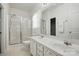 Bright primary bathroom features a dual sink vanity and glass enclosed shower at 19416 Fridley Ln, Cornelius, NC 28031