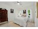 A bright bedroom featuring two windows with white curtains and light walls at 19416 Fridley Ln, Cornelius, NC 28031