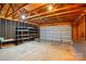 Spacious garage interior with high ceilings, exposed beams, shelving, and a large garage door at 19416 Fridley Ln, Cornelius, NC 28031