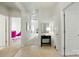 Bright hallway with neutral walls and a black accent table, showing the office in the background at 19416 Fridley Ln, Cornelius, NC 28031