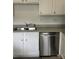 Clean kitchen with stainless steel dishwasher, a double sink, and white cabinets at 19416 Fridley Ln, Cornelius, NC 28031