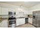 Bright kitchen featuring stainless steel appliances and white cabinetry at 19416 Fridley Ln, Cornelius, NC 28031