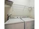 Functional laundry room equipped with a washer, dryer and shelving at 19416 Fridley Ln, Cornelius, NC 28031
