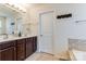 Modern main bathroom featuring double sink vanity with dark cabinets, framed mirror and tile floor at 2077 Taney Way, Fort Mill, SC 29707