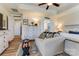 Bright main bedroom with tray ceiling and ceiling fan features cozy sitting area with sofa and decor at 2077 Taney Way, Fort Mill, SC 29707