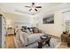 Relaxing main bedroom with tray ceiling, ceiling fan and sitting area with sofa and decor at 2077 Taney Way, Fort Mill, SC 29707