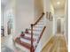 Bright foyer features a beautiful staircase with hardwood steps and white risers and a light hardwood floor at 2077 Taney Way, Fort Mill, SC 29707
