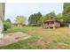 Charming backyard featuring a rustic wooden shed, partially fenced-in yard, and ample green space at 212 Pine St, Rockwell, NC 28138