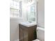 Bathroom sink with dark cabinets and natural light from a nearby window at 212 Pine St, Rockwell, NC 28138