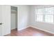Sunlit bedroom with hardwood floors, closet, and window at 212 Pine St, Rockwell, NC 28138