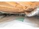 Crawl space featuring encapsulated moisture barrier, accessible plumbing, and wooden beams at 212 Pine St, Rockwell, NC 28138