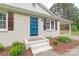 Inviting entrance with a blue front door, brick steps, and manicured landscaping at 212 Pine St, Rockwell, NC 28138