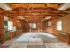 Interior of shed featuring wood paneling, exposed rafters, built in shelving, and workbench at 212 Pine St, Rockwell, NC 28138