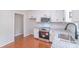 Updated kitchen with stainless steel oven and microwave, granite countertops, and white cabinets at 212 Pine St, Rockwell, NC 28138