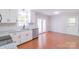 Bright kitchen with white cabinets, stainless steel appliances, and hardwood floors at 212 Pine St, Rockwell, NC 28138