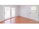 Neutral room with hardwood flooring and double doors leading to the outside at 212 Pine St, Rockwell, NC 28138