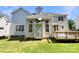 Back of house features a deck, siding, several large windows and lush green lawn at 2163 Woodstream Rd, Harrisburg, NC 28075