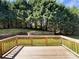 View of backyard and treeline from wooden deck and railing at 2163 Woodstream Rd, Harrisburg, NC 28075
