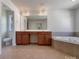 Bathroom featuring dual sink vanity, tile flooring and soaking tub at 2163 Woodstream Rd, Harrisburg, NC 28075