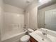 Cozy bathroom features tub with shower and sink with small vanity mirror at 2163 Woodstream Rd, Harrisburg, NC 28075