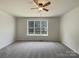 Bedroom with plush carpet and large window with backyard view at 2163 Woodstream Rd, Harrisburg, NC 28075