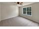 Bright bedroom features a ceiling fan and a window with view of greenery at 2163 Woodstream Rd, Harrisburg, NC 28075
