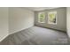 A bright bedroom with large windows and neutral carpeting at 2163 Woodstream Rd, Harrisburg, NC 28075