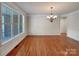 Dining room features hardwood floors, modern chandelier and large windows at 2163 Woodstream Rd, Harrisburg, NC 28075
