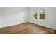 Bright bedroom with wood floors, closet, and large windows at 224 Adrian St, Mount Holly, NC 28120