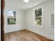 Charming bedroom featuring wood-look flooring and bright windows at 224 Adrian St, Mount Holly, NC 28120