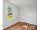 Bright bedroom with wood-look floors, natural light, and built-in shelving at 224 Adrian St, Mount Holly, NC 28120
