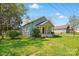An exterior view showcasing the home's well-maintained lawn and surrounding greenery at 224 Adrian St, Mount Holly, NC 28120