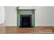 Close-up of the fireplace with dark brick and green mantel at 224 Adrian St, Mount Holly, NC 28120
