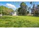 Spacious backyard with a single-story house surrounded by mature trees at 224 Adrian St, Mount Holly, NC 28120