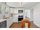 Bright kitchen with stainless steel appliances, white cabinets, and wood floors at 224 Adrian St, Mount Holly, NC 28120