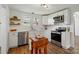 Renovated kitchen featuring white cabinets, stainless appliances, and butcher block island at 224 Adrian St, Mount Holly, NC 28120