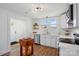 Updated kitchen with stainless steel appliances, white cabinetry, and butcher block island at 224 Adrian St, Mount Holly, NC 28120