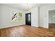 Bright living room with wood floors, black cabinet, and large window offering natural light at 224 Adrian St, Mount Holly, NC 28120