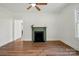 Bright, open living room with hardwood floors and a charming decorative fireplace at 224 Adrian St, Mount Holly, NC 28120