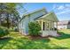 A side view showing the house's design and landscaping at 224 Adrian St, Mount Holly, NC 28120