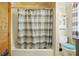 Compact bathroom showcasing a bathtub with shower, toilet, and vanity at 247 W Park Ave, Charlotte, NC 28203
