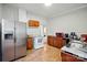 Functional kitchen featuring stainless steel refrigerator and white appliances, providing a practical cooking space at 247 W Park Ave, Charlotte, NC 28203