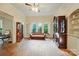 Living room showcasing hardwood floors, vintage furniture, and lots of bright, natural light from many windows at 247 W Park Ave, Charlotte, NC 28203