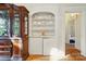 Living room displaying a built-in shelf and cabinets with an open doorway that leads into a room with a bed at 247 W Park Ave, Charlotte, NC 28203
